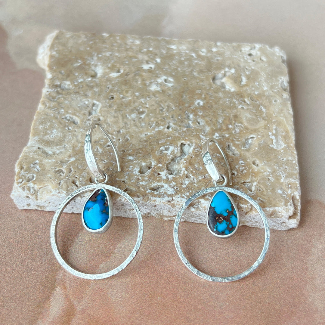 These deep-blue stones have a beautiful copper matrix and are framed with sterling silver hoops. A linen-texture gives the hoops an organic look & subtle shine.  Perfect to wear for summer or pack for your summer getaway.