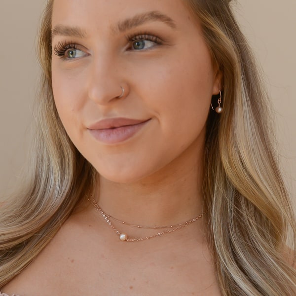 Elegant jewelry ensemble to wear every day or to a dinner date.   Elevate your look with this delicate single pearl necklace layered with a rose gold-filled chain. Featuring a shimmery, creamy-rose colored pearl that is delicately set on a 14kt rose gold-filled chain, creating a luminous effect that captures the light beautifully.