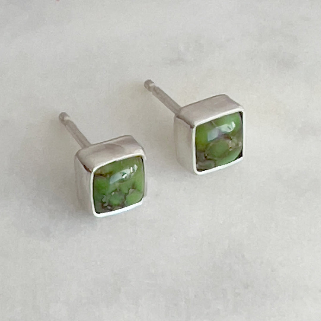 Small Turquoise and sterling silver square studs. Green color with brown matrix.