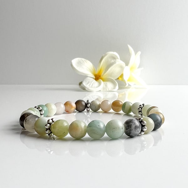Need a little peaceful energy in your life? Try this Amazonite stretch bracelet with gems showing beautiful green and blue colors with the addition of black and gold hues. A comfortable stretch bracelet to add to your wrist stack. Front view