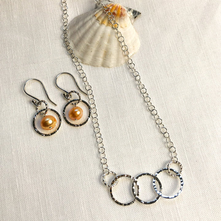 Fresh as summer- Apricot Pearl & Silver circle earrings paired with the matching Lightweight & Graceful Silver Hammered Circle Necklace. Great as a gift for your friend, or sister, or as a gift for yourself. Lovely as a bridesmaid gift. Handcrafted in California. 