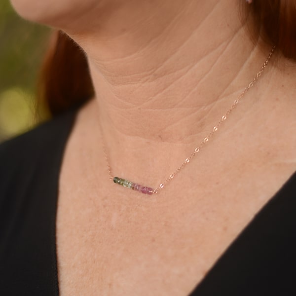 This tourmaline bar necklace is sure to tantalize with its enchanting pink and green Tourmaline gems. Crafted with a 14Kt rose-gold chain, the necklace sits lovingly on your neck. Add a touch of subtle glamour to any look with this sophisticated necklace. Pair with delicate earrings to express your minimalist look. Shown worn on model.