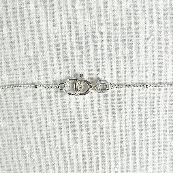 Show your love with this romantic and feminine heart necklace. Crafted from fine silver and strung along an 18” dainty chain, it is the perfect way to add a touch of delicate beauty to your everyday look. Clasp detail