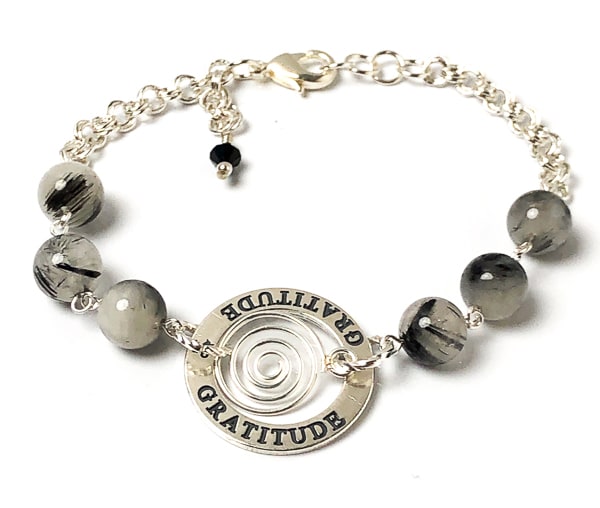 Is GRATITUDE your affirmation this year? This highly polished sterling silver circle charm is engraved on both sides and the lovely spiral drop gives it some whimsey. Milky white quartz with striking black needle-like inclusions of black tourmaline.  Handcrafted in CA
