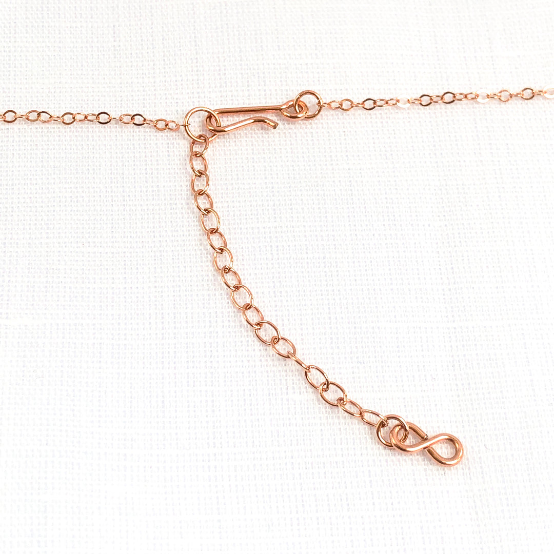 Delicate Pink Opal gemstone and Rose Gold-filled bar necklace. Perfect alone or for layering. The shine of the Rose Gold stardust bead compliments the opals nicely and gives the necklace an air of sophistication. Clasp view. Handcrafted.