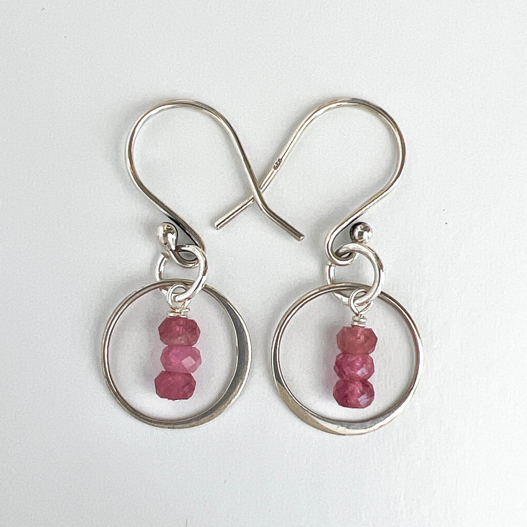 Discover the natural radiance and rainbow of colors of this tantalizing gemstone.  Stunning Tourmalines in raspberry pink are lovingly encircled with a sterling silver focal. Ear wire detail view.