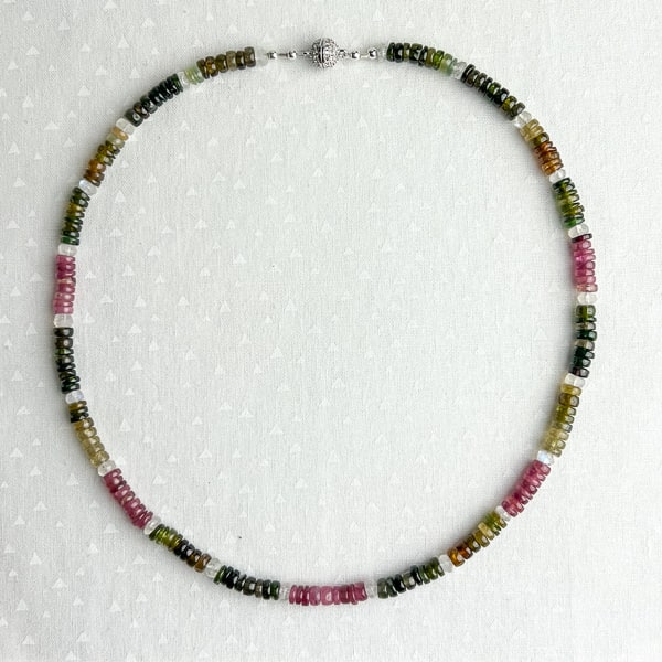 Dazzling Tourmalines framed by Rainbow Moonstones highlight the raspberry pink, seafoam & forest green, and translucent amber colors of the gems. Elevate your casual Friday look with this easy-wearing necklace that shimmers in the sunlight. Tourmaline is the birthstone for October & the gem of the 8th anniversary.
