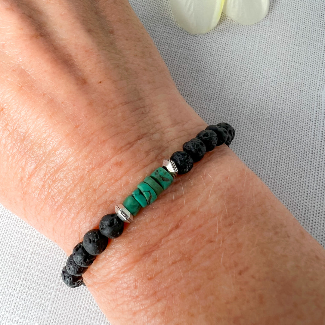 The small sea-green heishi beads are a powerful combination with the black lava rock and antique silver spacer beads. Lava Beads can absorb essential oils for relaxation. Handcrafted in California. Shown on wrist.