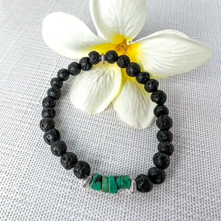 The small sea-green heishi beads are a powerful combination with the black lava rock and antique silver spacer beads. Lava Beads can absorb essential oils for relaxation. Handcrafted in California. 